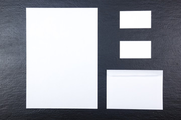 Business card. Corporate stationery set mockup. Blank textured brand ID elements on wooden table. Top view.