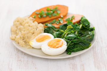 sweet potato with quinoa, boiled egg in dish