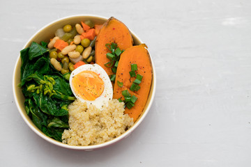 sweet potato with quinoa, boiled egg in dish