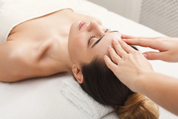 Fototapeta na wymiar Woman getting professional facial massage at spa