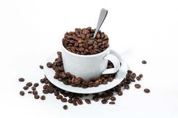 mug with coffee beans on white background, concept photo