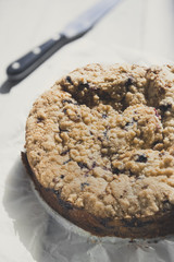 Tasty berries coffee cake on white wooden table. Vertical.