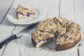 Tasty berries coffee cake on white wooden table. Horizontal.