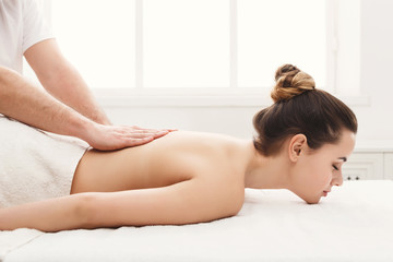 Obraz na płótnie Canvas Closeup of hands massaging female back