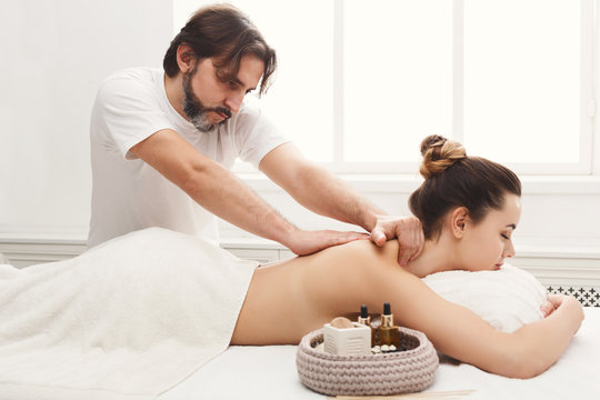 Male masseur doing professional body massage