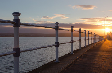Fototapeta premium Sunrise over the Esplanade in Weymouth at Pavilion and Jurassic Skyline