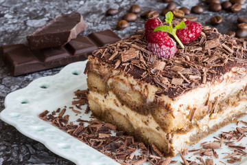 Homemade Tiramisu Cake Dessert with Grated Chocolate, Raspberry and Mint