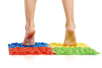 Child on massage mat doing exercises for flatfoot prevention