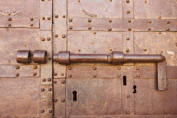 Close-up shot of an ancient latch on an old rusty door