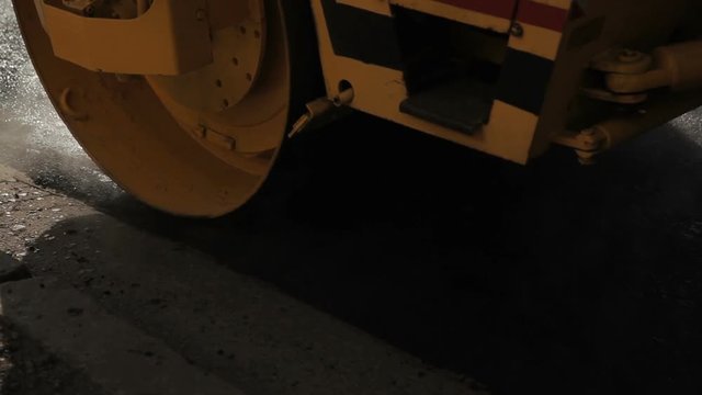 Road roller working on the new road construction site