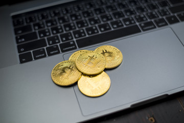 Bitcoin coins on a laptop  keyboard