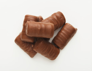 Small chocolate candies isolated on white