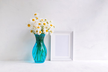 Mockup with a white frame and white daisies in a vase