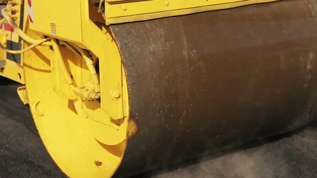 Road roller working on the new road construction site