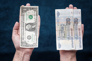 hands holding dollar and Russian rubles - obrazy, fototapety, plakaty
