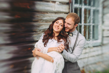 Bride and groom hugging in a forest near the horse in the autumn forest, wedding walk