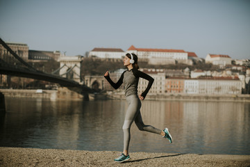 Young female athlete running on the waterfront in Budapest, Hungary