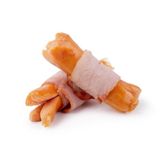 Small sausages wrapped in a blanket of smoked streaky bacon isolated on white background