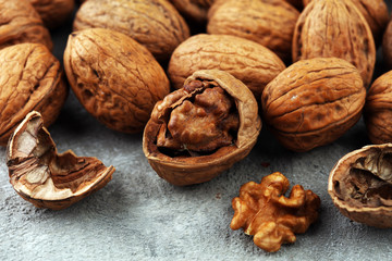 Walnut kernels and whole walnuts on rustic old table
