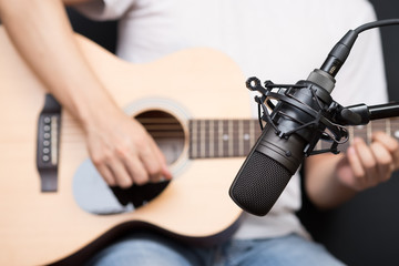 condenser microphone recording acoustic guitar sound in music studio