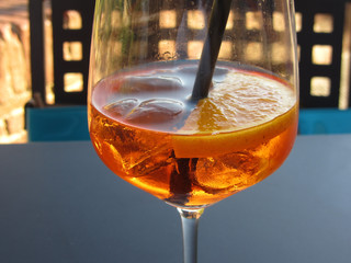 Summer refreshing aperitif drink on the rocks . Spritz cocktail with lemon slice