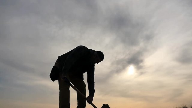 50 years old man digging with a spade silhouette 