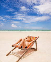 funny boy in beach chair on the beach