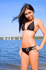 Obraz premium Woman in bikini at river coast