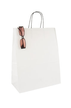 Shopping bag and eyeglasses isolated on white background