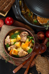 Roast in a clay pot rustic style view from above