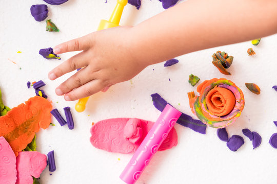 Children are molding colorful clay dough to various beautiful shape with imagination