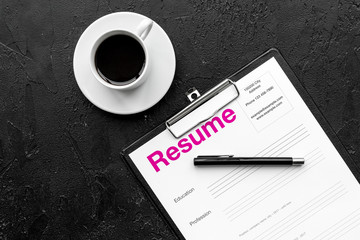 Recruitment. Select employees. Resume near coffee, glasses on black background top view