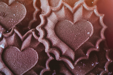 Chocolate cupcakes in the form of hearts - fresh pastries, the concept of declaration of love, toning