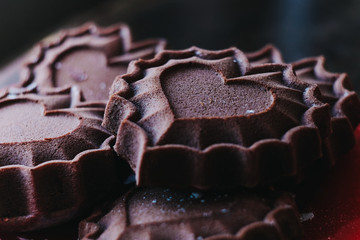 Appetizing chocolate cupcakes in the form of hearts - fresh pastry on a plate, concept of declaration of love
