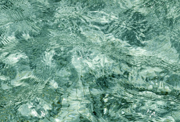 Natural clear water texture background.Blue swimming pool aqua surface.Selective focus.