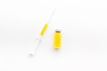 Syringe with colored drug. Injection concept on white background top view copy space