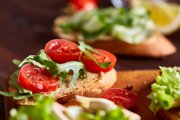 Breakfast sandwich with homemade paste, vegetables and fresh greens, shallow depth of field