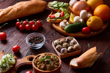 Breakfast still life with sandwiches, quail eggs, spicies and fresh fruits and vegetables, selective focus