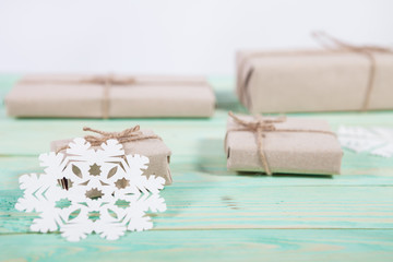 Gift boxes wrapped kraft paper tied with twine and paper snowflake and tied with twine. with copy space