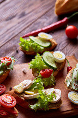 Breakfast sandwich with homemade paste, vegetables and fresh greens, shallow depth of field