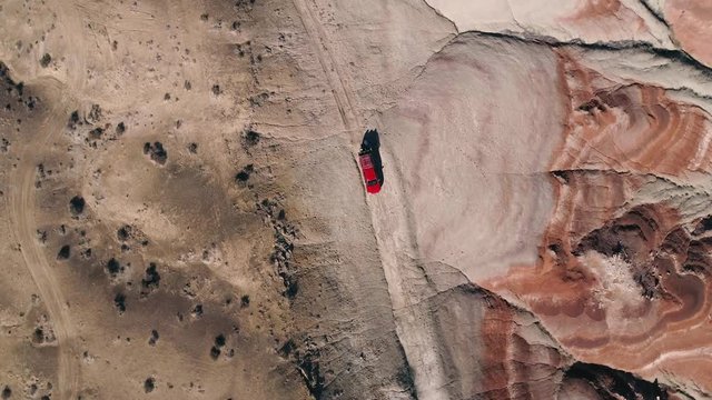 Rotating aerial view of truck on dirt road in the Utah desert near Hanskville.