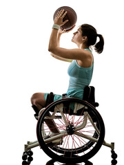 Naklejka premium one caucasian young handicapped basket ball player woman in wheelchair sport tudio in silhouette isolated on white background