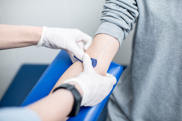 Gluing adhesive plaster after the procedure of blood taking for test in the laboratory