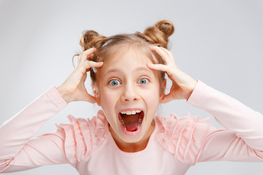 Little Girl Pleasantly Surprised Expression On Gray Background