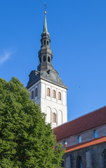 Fototapeta na wymiar The tower and spire of St. Nicholas Church, former Lutheran Church, built in the 13th century in Tallinn, Estonia