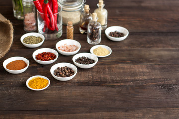 Spices and herbs. Variety of spices and herbs on a dark wooden surface
