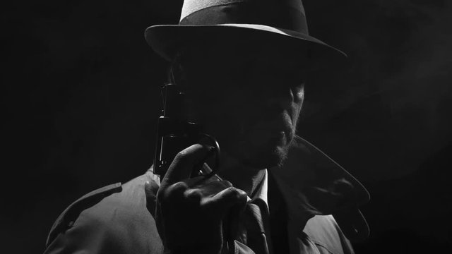 Retro detective spy holding a revolver