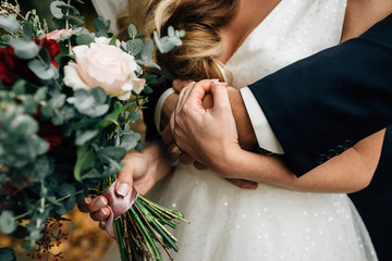 the bridegroom embraces the bride