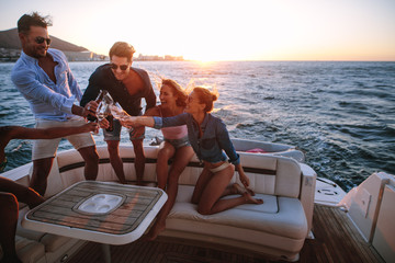 Young people having a boat party at sunset