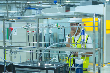 Asian engineer working at Operating hall,Thailand people wear helmet  work,He worked with diligence and patience